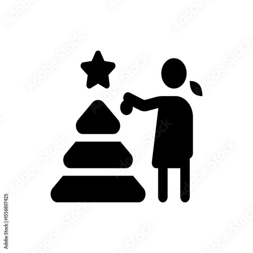 Silhouette of a woman decorating a christmas tree with a star on top and holding an ornament in her hand