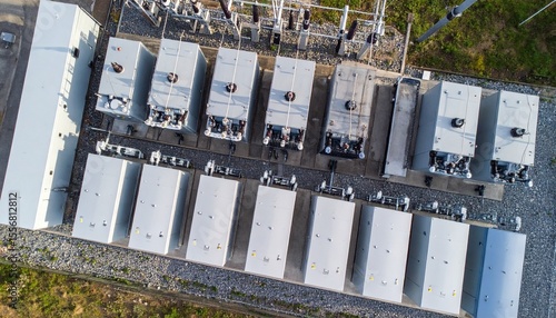 multiple BESS containers aligned in a row, labeled HV and MV, with a power transformer: