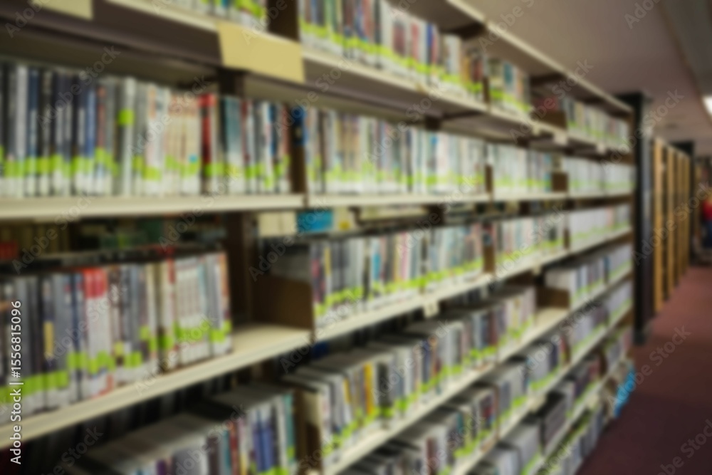 Fototapeta premium Defocused image of books in bookshelf