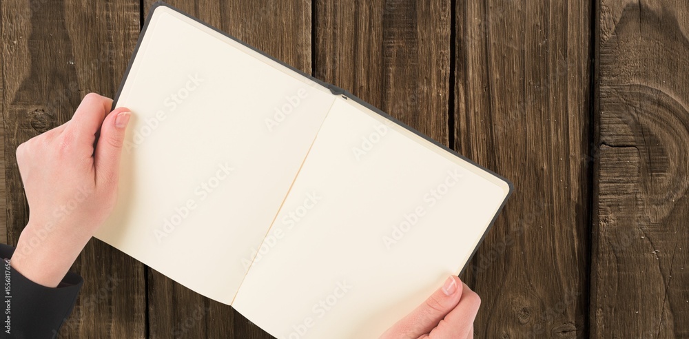 Naklejka premium Overhead view of hand holding book
