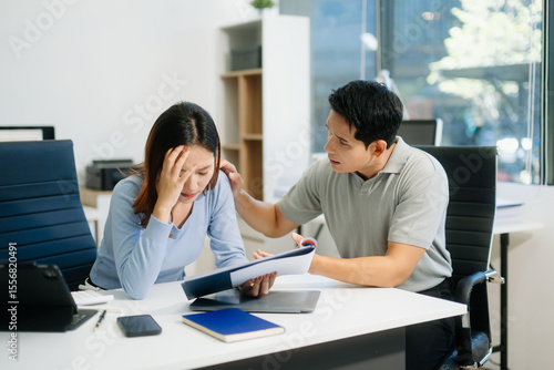 A stressed business team in shock after financial failure. Upset colleagues brainstorm solutions, reacting to bad news
