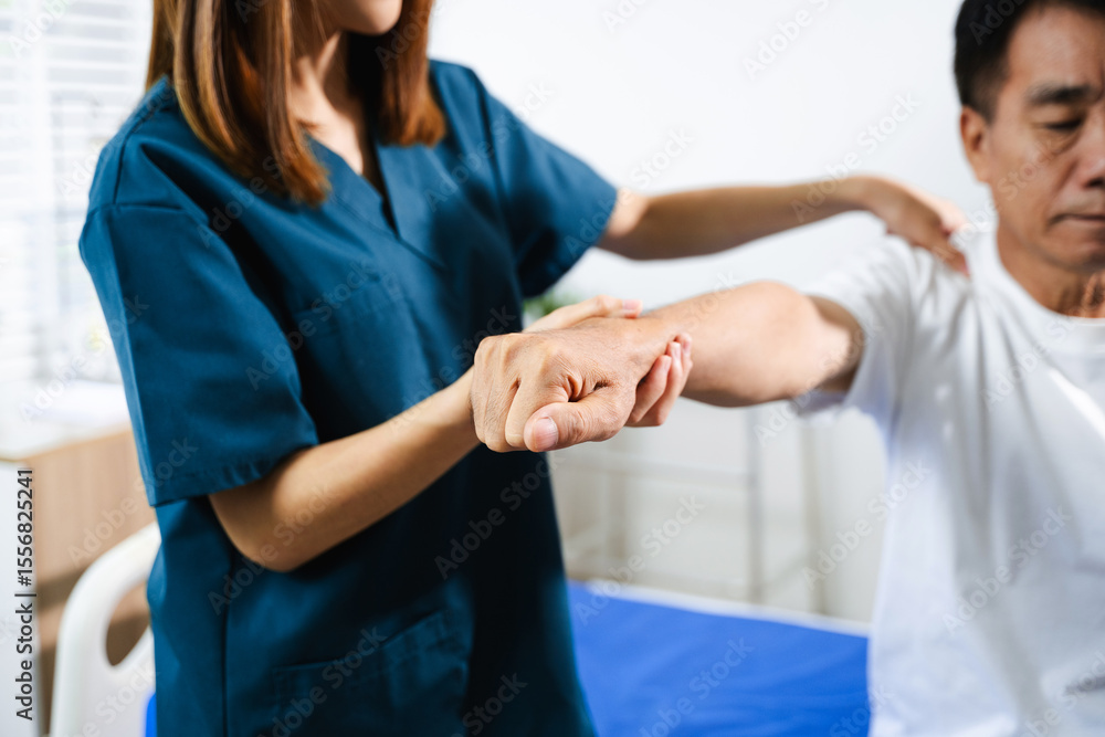 Female physiotherapist supports arm movement exercise for senior male patient during rehabilitation. Elderly care Female physiotherapist supports arm movement exercise for senior male patient during rehabilitation. Elderly care