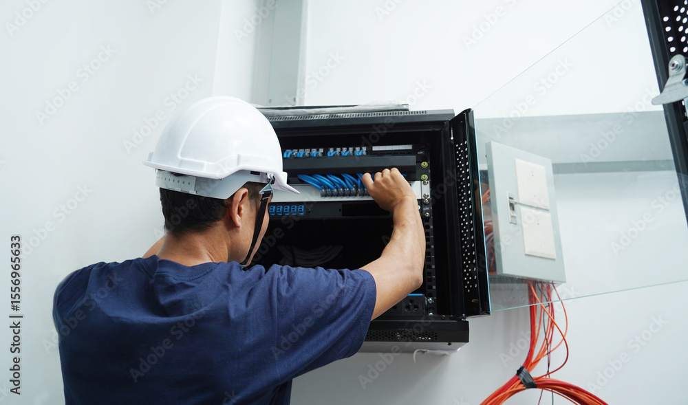 Αυτοκόλλητο A maintenance technician works in a server room with a fiber optic hub