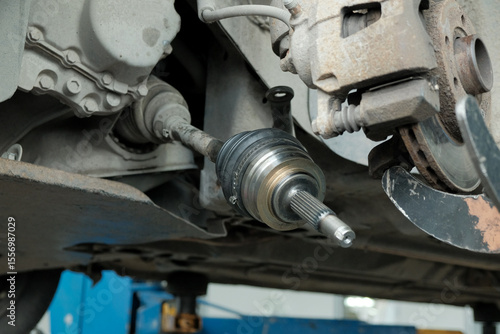 Car service. Repair of the car's front suspension.Replacement of the CV joint. A close-up of the part that transmits the torque from the gearbox to the front wheels.