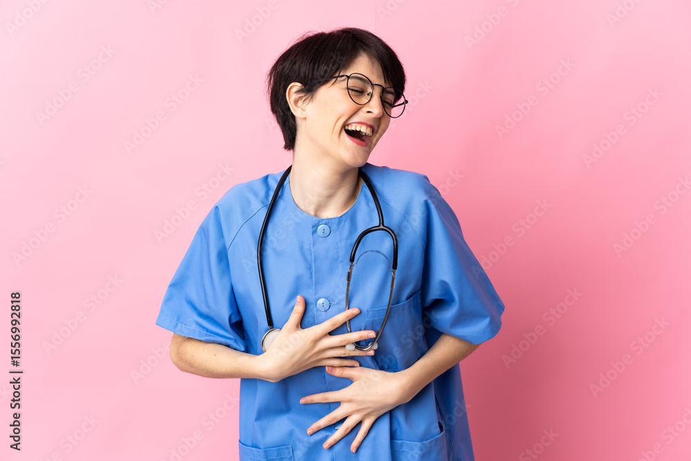 Surgeon isolated on pink background smiling a lot Surgeon isolated on pink background smiling a lot