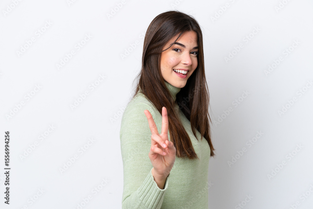 Young Brazilian woman isolated on white background smiling and showing victory sign Young Brazilian woman isolated on white background smiling and showing victory sign
