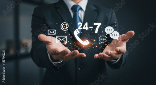 Professional Man Presenting Glowing Support Icons in Dark Suit Against a Dark Background Demonstrating Customer Service and Communication
