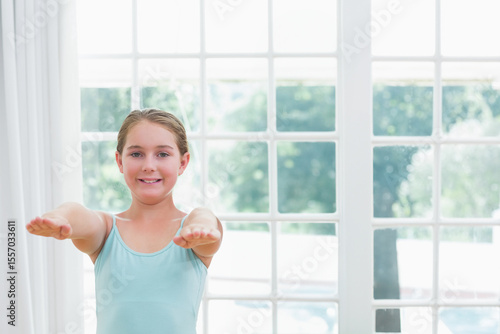 School-age girl in blue top extending arms horizontally at home by multi-pane window, copy space Free Download School-age girl in blue top extending arms horizontally at home by multi-pane window, copy space - GFXLoad