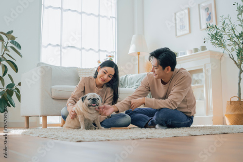 Asian family stay at home together with dog on holiday. Love couple lifestyle.