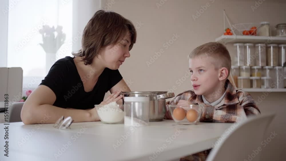 A loving mother and son bonding in the kitchen, cooking together with joy and laughter. Heartwarming family moments filled with care and happiness A loving mother and son bonding in the kitchen, cooking together with joy and laughter. Heartwarming family moments filled with care and happiness