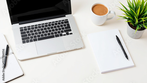 white desk with a laptop computer sitting on top of it, next to a cup of coffee and a potted plant
