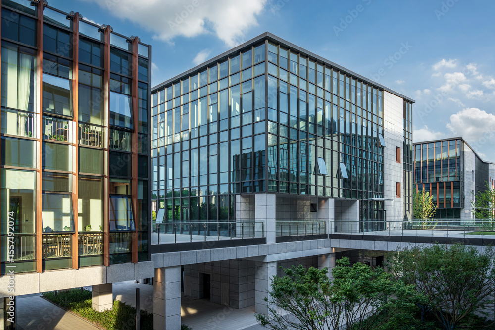 Fototapeta premium Stunning Modern Architecture Showcasing Glass and Stone Elements Under Clear Skies