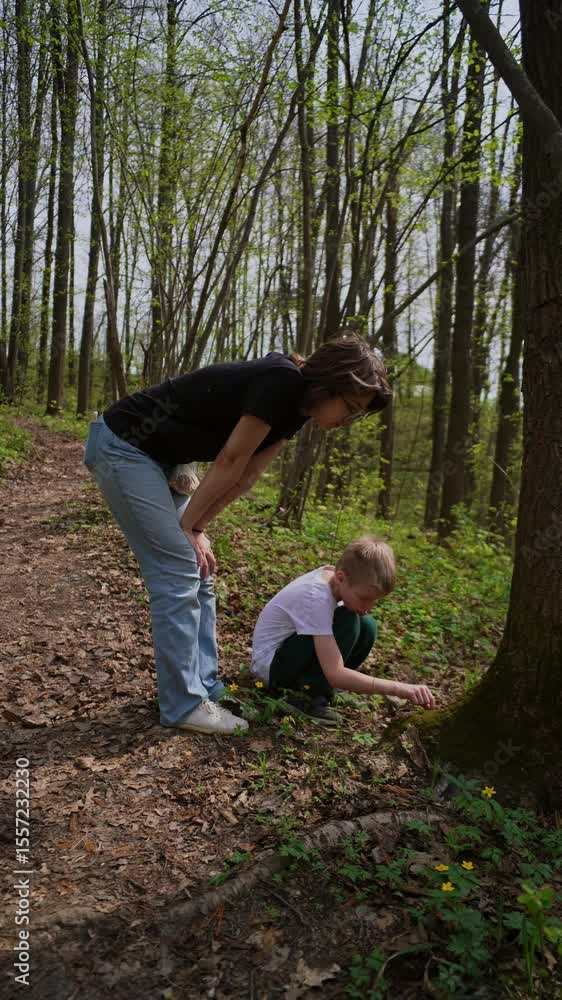 mother and her son with a hearing aid enjoy a peaceful forest walk, sharing a genuine moment of connection and rehabilitation in nature. Authentic, heartwarming family bonding mother and her son with a hearing aid enjoy a peaceful forest walk, sharing a genuine moment of connection and rehabilitation in nature. Authentic, heartwarming family bonding