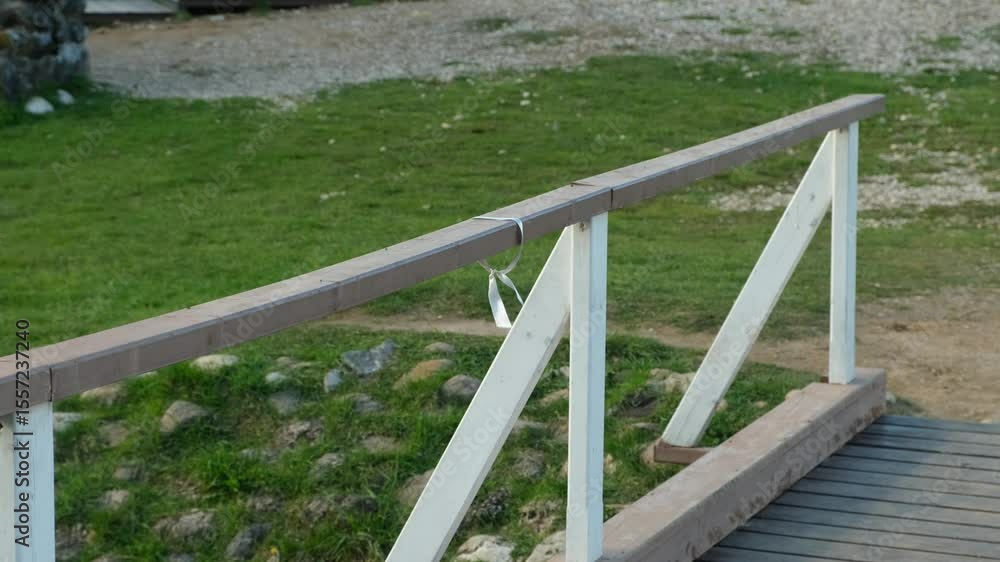 ribbon on the railing of a wooden bridge ribbon on the railing of a wooden bridge