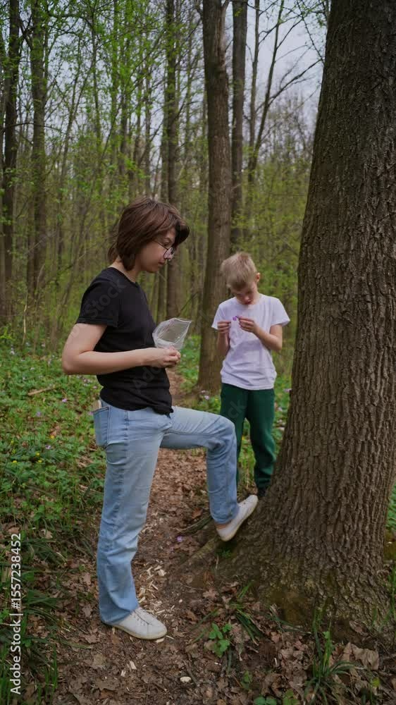 mother and her son with a hearing aid enjoy a peaceful forest walk, sharing a genuine moment of connection and rehabilitation in nature. Authentic, heartwarming family bonding mother and her son with a hearing aid enjoy a peaceful forest walk, sharing a genuine moment of connection and rehabilitation in nature. Authentic, heartwarming family bonding