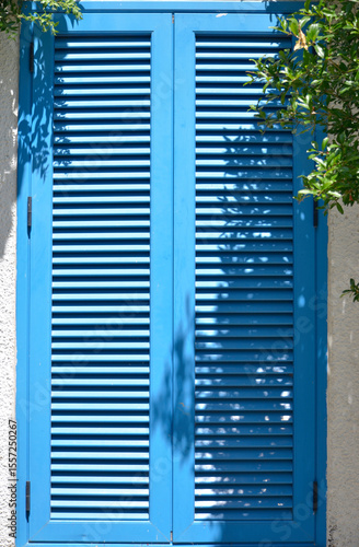 window on a house with wooden shutters closed