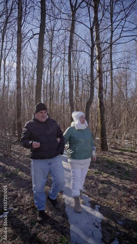 elderly couple enjoys a peaceful walk in the forest, holding hands and smiling. Authentic, unposed moment of love and connection in nature. Perfect for lifestyle, wellness, and aging-related content elderly couple enjoys a peaceful walk in the forest, holding hands and smiling. Authentic, unposed moment of love and connection in nature. Perfect for lifestyle, wellness, and aging-related content