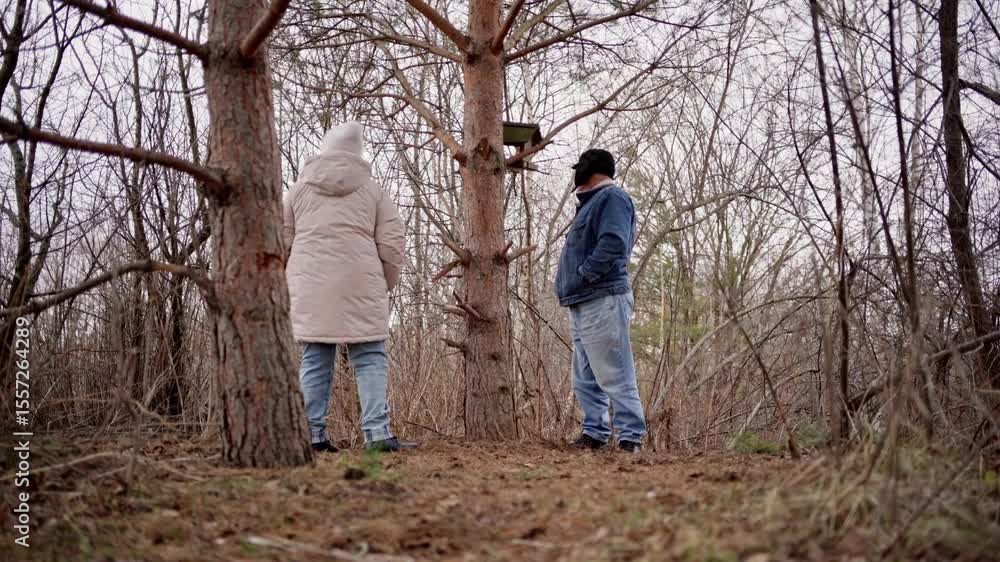 An elderly couple enjoys a peaceful walk in the forest, holding hands and smiling. Authentic, unposed moment of love and connection in nature. Perfect for lifestyle, and aging-related content An elderly couple enjoys a peaceful walk in the forest, holding hands and smiling. Authentic, unposed moment of love and connection in nature. Perfect for lifestyle, and aging-related content