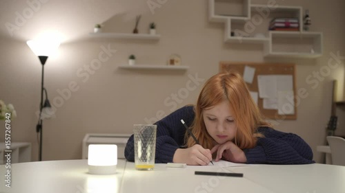 A focused 12-year-old girl does homework in a cozy living room, surrounded by books and a laptop. Warm lighting highlights her concentration and authentic study routine perfect for education family