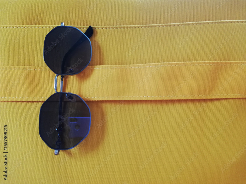 Fototapeta premium glasses on yellow bag