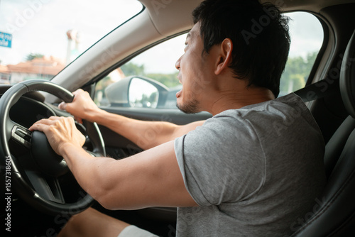 Schilderij op canvas Angry Asian man reacting strongly honk the horn while driving car