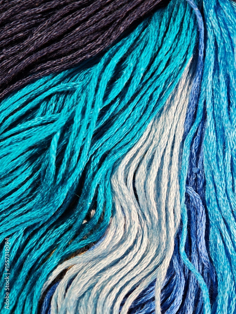 Fototapeta premium Sky blue and blue threads, macro embroidery yarn, crafting