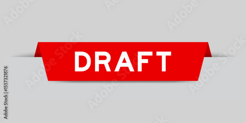 Red color inserted label with word draft on gray background