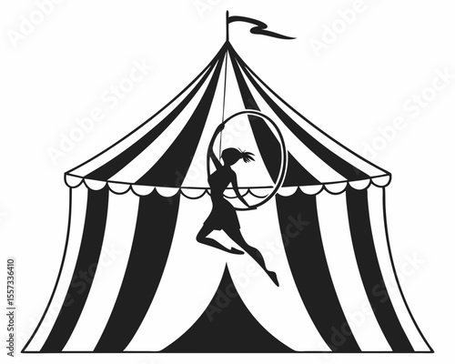 Silhouette of an acrobat performing on a circus aerial hoop under a tent
