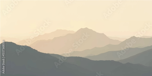 A stunning alpine scene emerges, with peaks covered in clouds and mist and illuminated by the gentle tones of dawn or dusk.