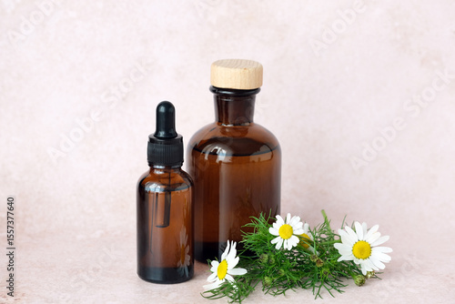 Wallpaper Mural Three brown glass bottles arranged artfully alongside a basket of chamomile flowers. Natural aesthetic ideal for herbal remedies. Alternative medicine, healthy and well-being theme concept Torontodigital.ca