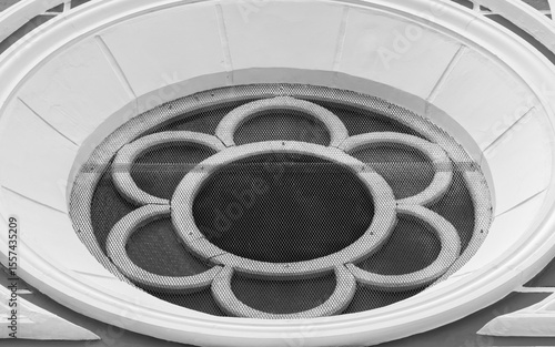 Circular rose window with floral gothic motif. Symbolic and symmetrical architectural element often found in cathedrals, ideal for sacred art and design.