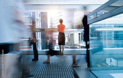 Woman standing on footbridge and thinking