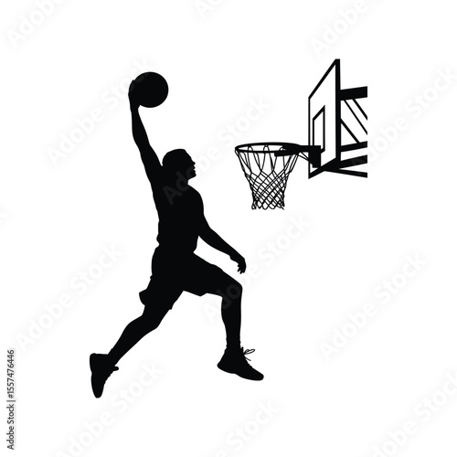 Silhouetted basketball player executing a slam dunk towards the basketball hoop in motion