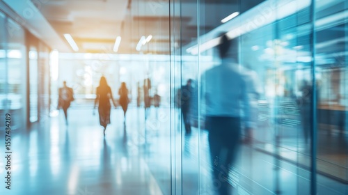 Abstract glass wall of corporate office with blurred people walking in professional business environment perfect for finance technology and modern workplace concept backgrounds
