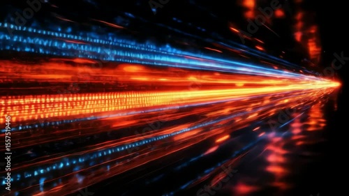 Lines of light streak across the black background primarily in blue and orange colors