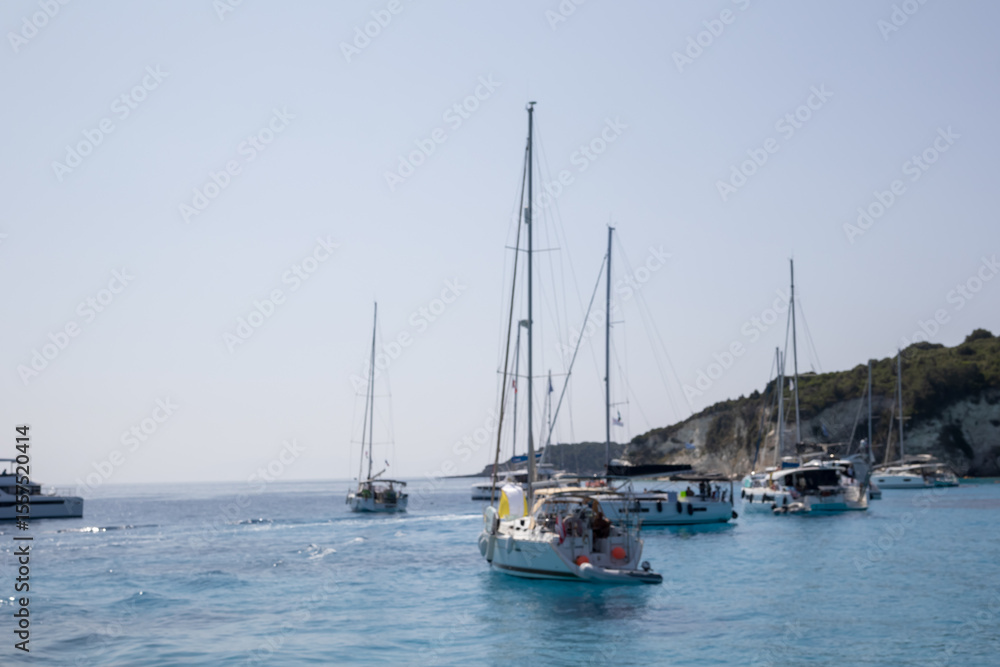 abstract blur sailboats on calm turquoise sea under clear sky abstract blur sailboats on calm turquoise sea under clear sky