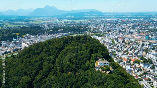 Salzburg, Austria, aerial view of the historic old town with Hohensalzburg Fortress, Salzach River, baroque architecture and surrounding Alps. Captured on a sunny summer day from a drone