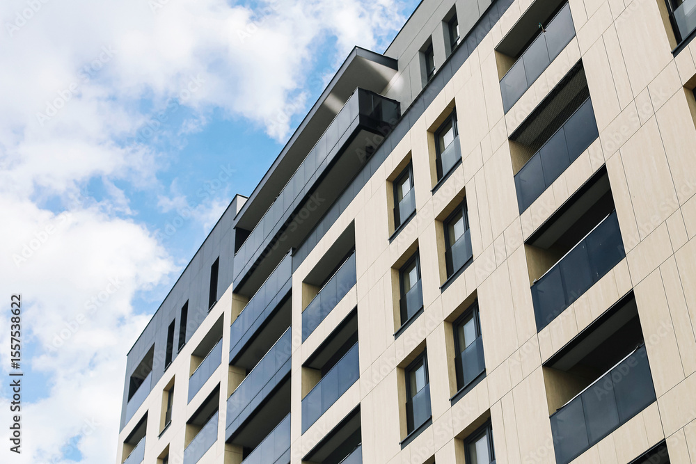 Modern residential apartment building. Facade with balconies and windows. Urban housing architecture. New real estate development. Contemporary city lifestyle. Cloudy sky in background. Urban growth. Modern residential apartment building. Facade with balconies and windows. Urban housing architecture. New real estate development. Contemporary city lifestyle. Cloudy sky in background. Urban growth.