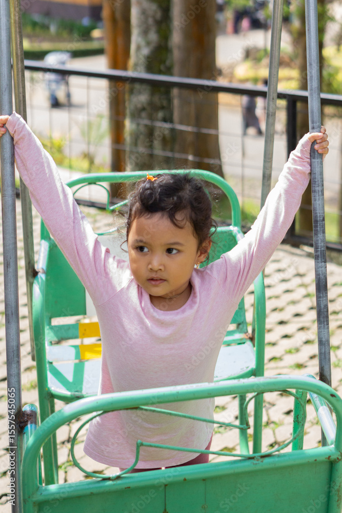 Fototapeta premium Daughter playing in backyard playground