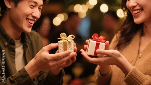 Two individuals exchanging gifts with joyful expressions in a warmly lit setting.