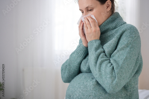 Photos Expecting mother using tissue while having cold during pregnancy