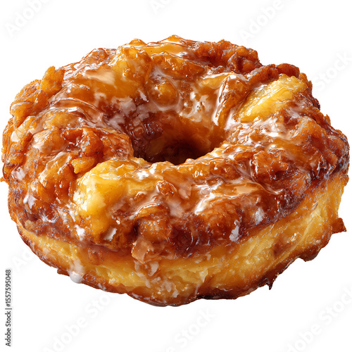A close up of a glazed apple fritter donut with a hole in the center on a black background