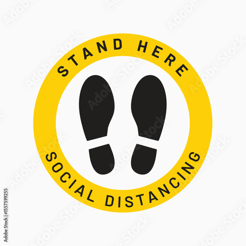 Social Distancing Reminder: A close-up view of a social distancing floor sticker. this visual element is a circular sign with bold text and footprint symbols.