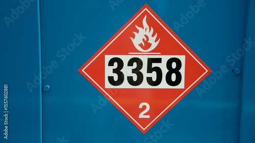 a red caution diamond marking flammable on a blue background
