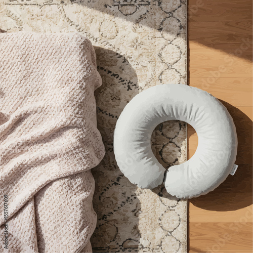 Cozy baby nursing pillow on soft blanket by the floor in sunlight  