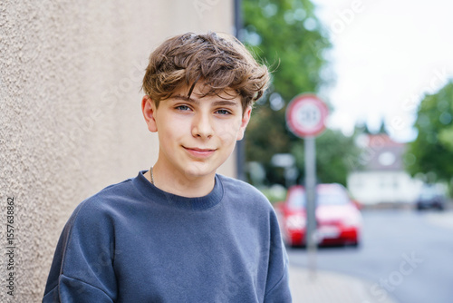 Portrait of smiling teenage schoolboy looking at camera. Happy teenage boy, smiling confidently into the camera. Portrait of a school kid enjoying student life. Education and youth lifestyle concept.