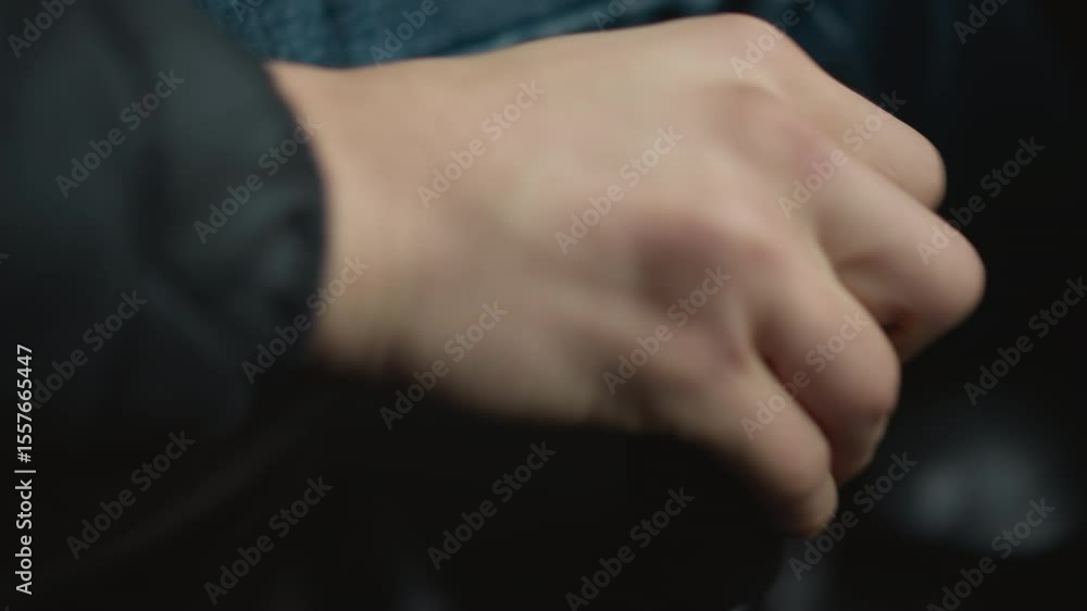 Close up of car enthusiast shifting gear lever forward with expert motion, wrist and knuckles guiding stick through precise control in cabin, emphasizing driver skill and tactile feel Close up of car enthusiast shifting gear lever forward with expert motion, wrist and knuckles guiding stick through precise control in cabin, emphasizing driver skill and tactile feel