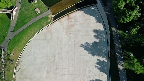 Top-down drone video flying over Városligeti-tó from Zielinski Bridge to Robinson Restaurant, capturing the lake's calm waters, greenery, and city park in Budapest.