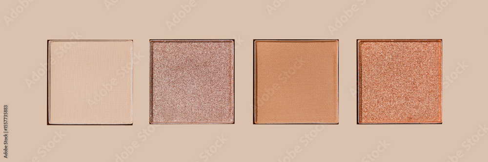 Fototapeta premium Closeup view Neutral Eyeshadow Palette with Matte and Shimmer, beige brown with golden shimmer shades. Top view of eyeshadow refills, Swatches powder eyeshadow or highlighter, cosmetic beauty, makeup