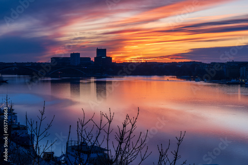 Canvas Print Dramatic sunset over Kungsholmen with bridge and city silhouette